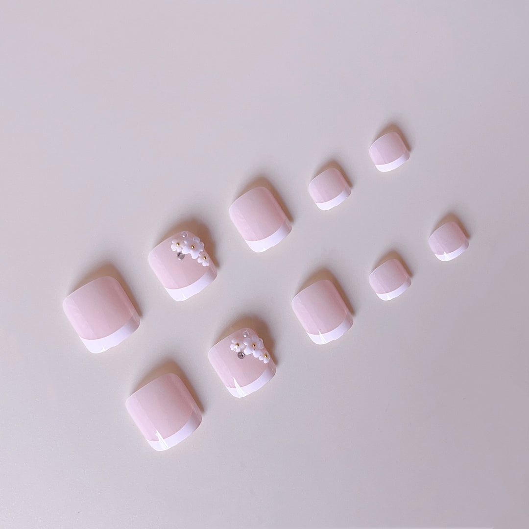 Elegant toenail art with delicate 3D floral decorations Kalsten