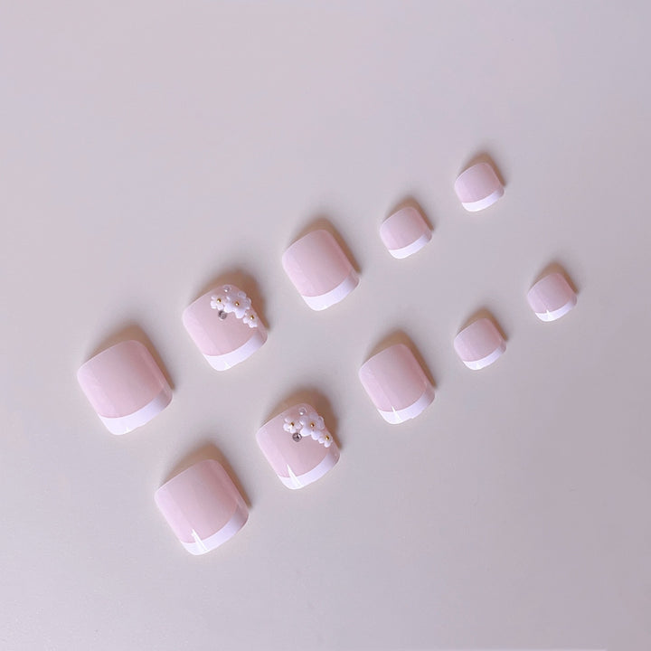 Elegant toenail art with delicate 3D floral decorations Kalsten