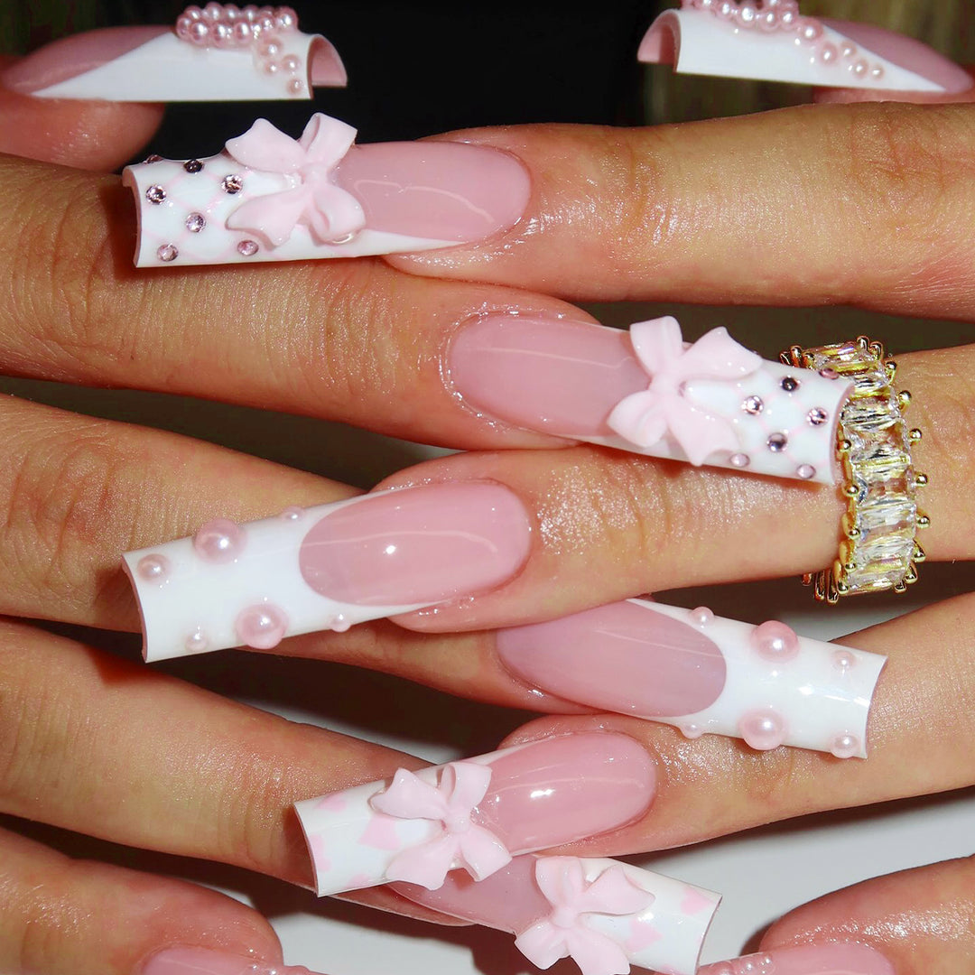 Artistic acrylic nails with bow and pearl decorations Kalsten