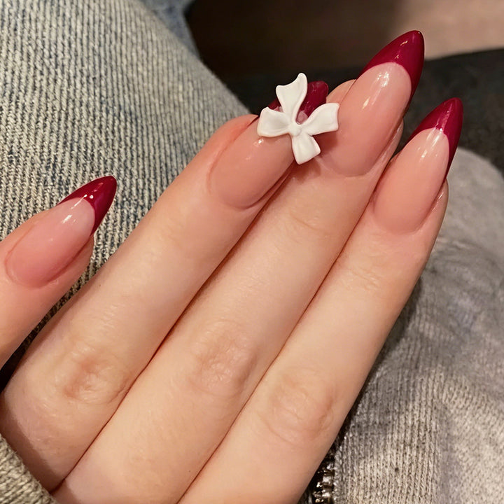 Acrylic nail set with creative French tip design and cute bows Kalsten