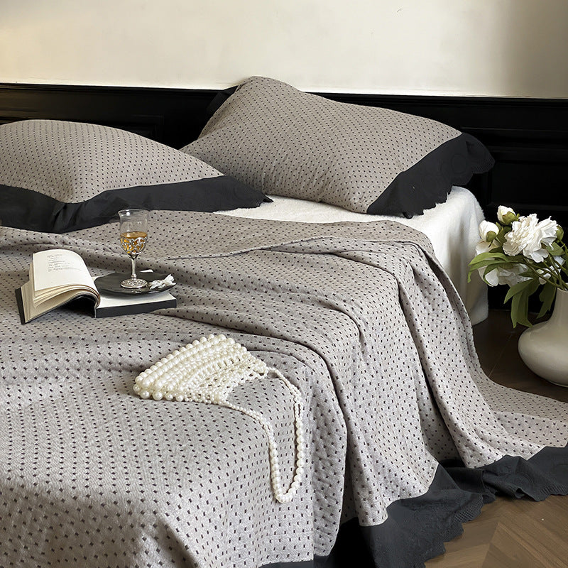 Quilted bedspread and pillowcase set with waffle texture and contrasting ruffle
