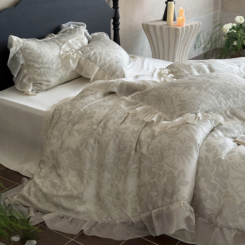 Elegant bedding set made of fine satin jacquard with delicate floral relief and decorative ruffle