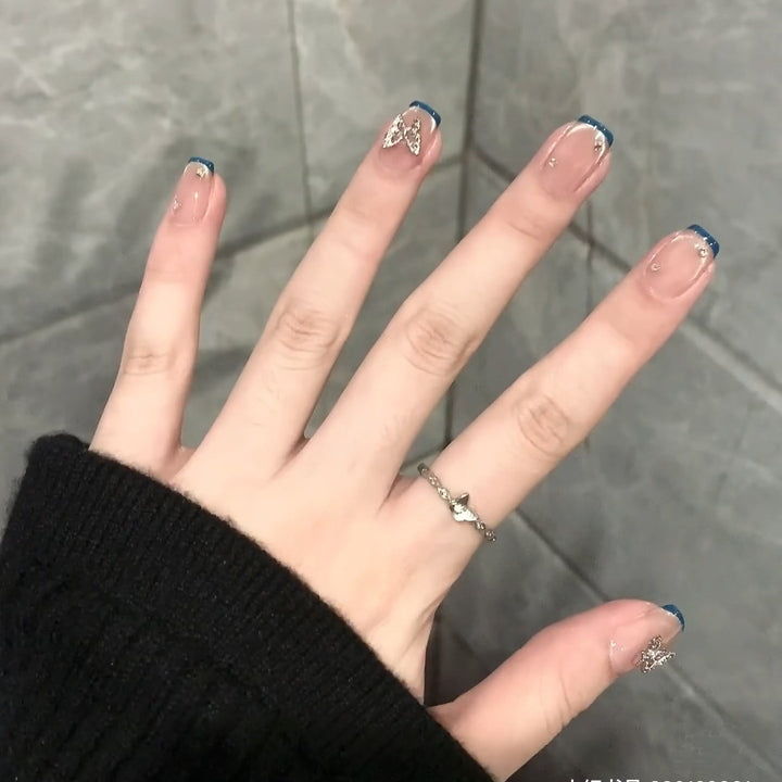 Artificial nails with trendy French tips and decorative glitter accents Kalsten