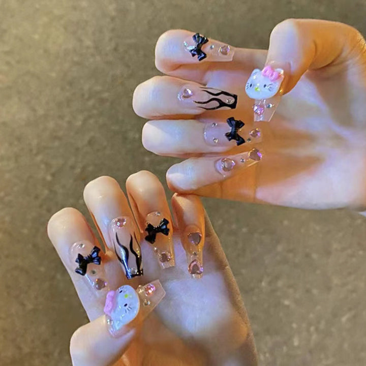 Artful nail extensions with Hello Kitty and floral accents Kalsten