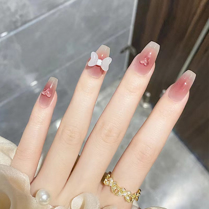 Artful acrylic nails with heart and bow design Kalsten
