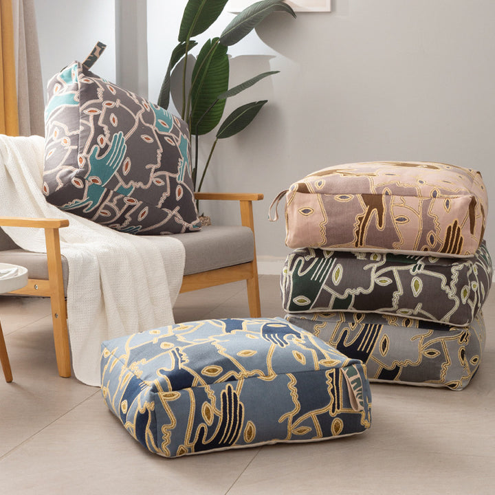 Square floor cushion cover with embroidered line pattern and carrying handle