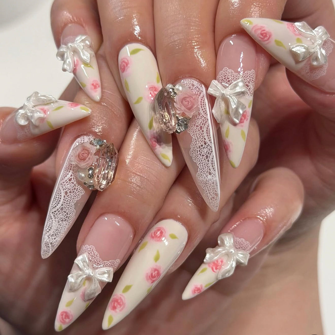 Artful stiletto nails with floral accents and glitter accents Kalsten