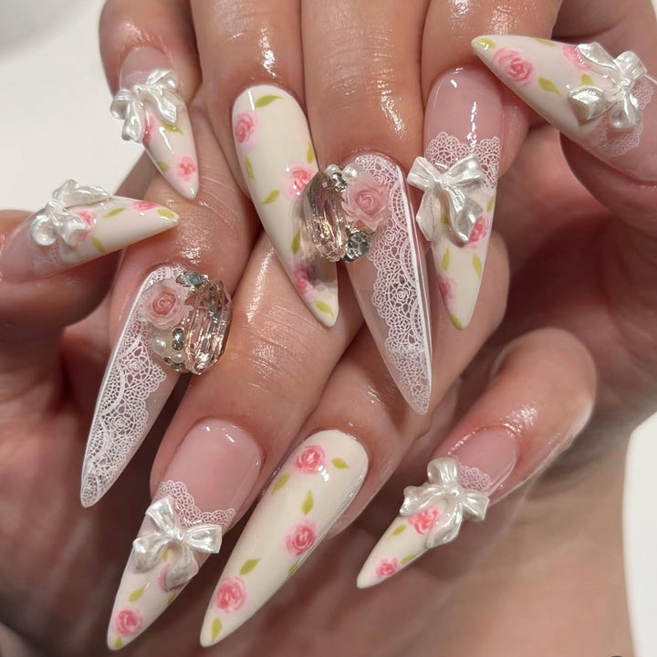Artful stiletto nails with floral accents and glitter accents Kalsten