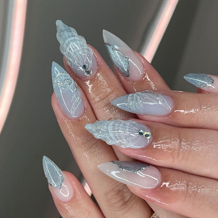 Artful stiletto nails with elegant glitter and floral design Kalsten