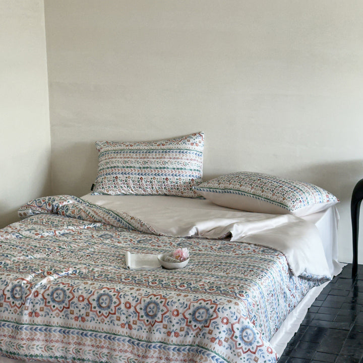 Satin bed linen set with ruffled bed skirt and floral printed pillowcases