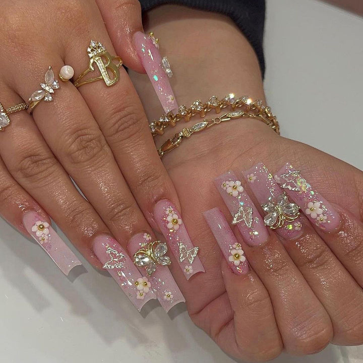 Artistic Nail Extensions with Glitter and Floral Accents Kalsten