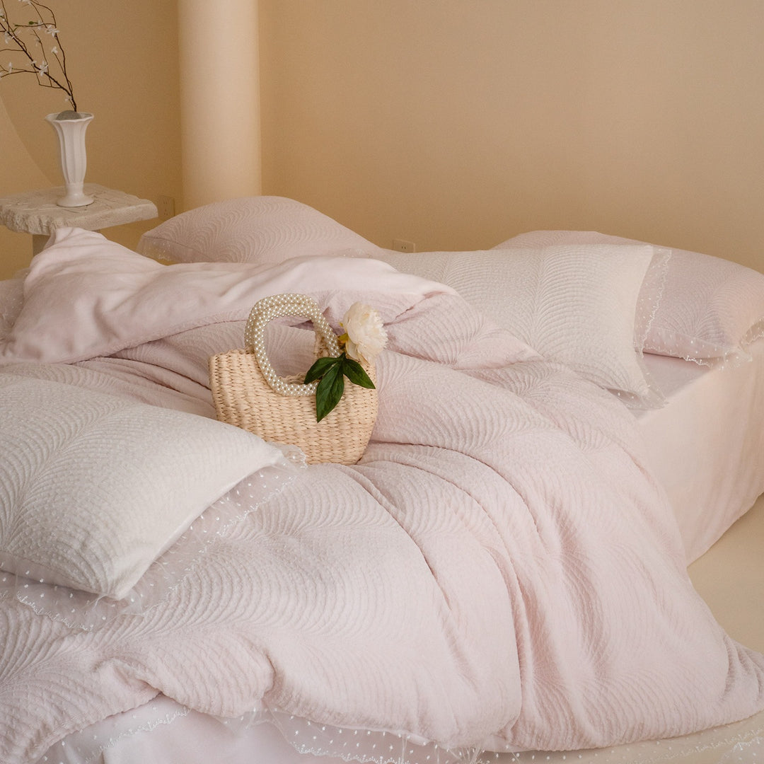 Quilted bedding set with lace edge and wave quilting pattern