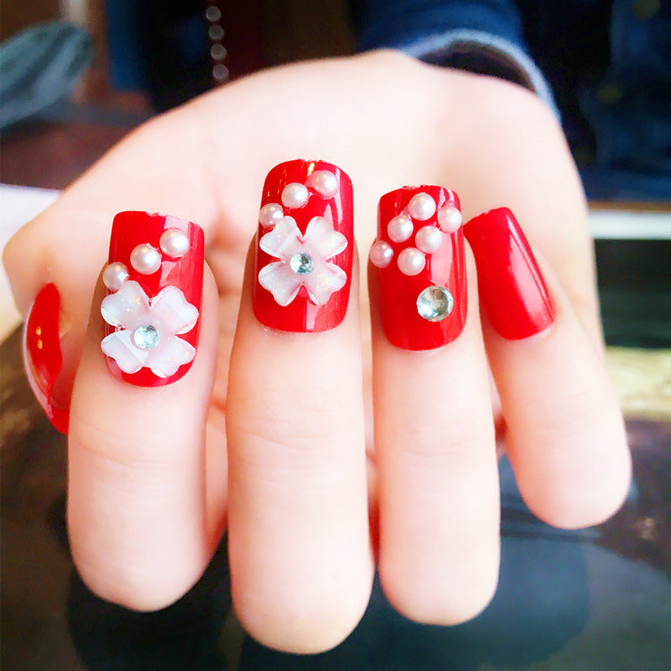 Artificials nails with sparkling rhinestone accents and elegant flower embellishments Kalsten