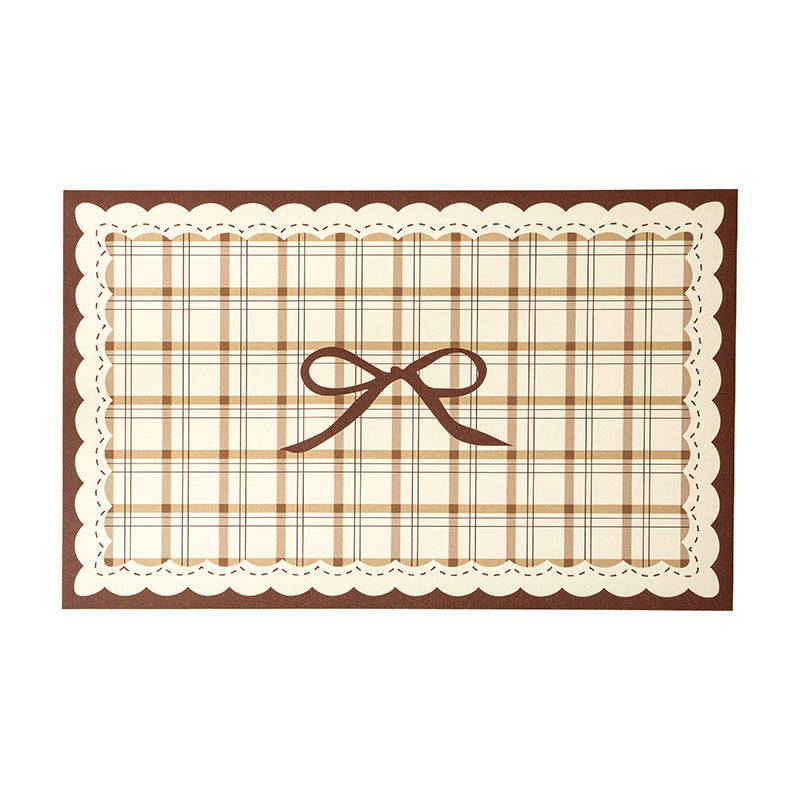 Rectangular wipeable placemat with checked pattern, wavy decorative edge and bow motif Kalsten