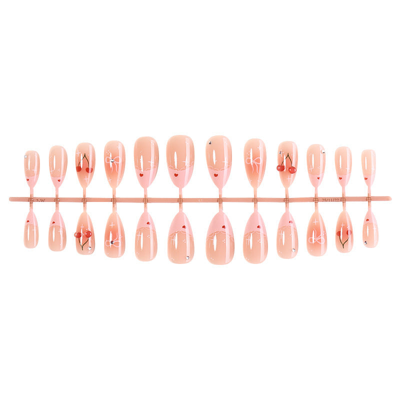 Artifical nails with playful heart and bow designs Kalsten