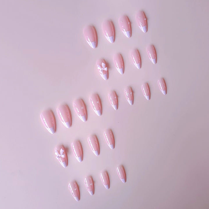 Artificial nail set with shimmering 3D bows and elegant pearl accents Kalsten