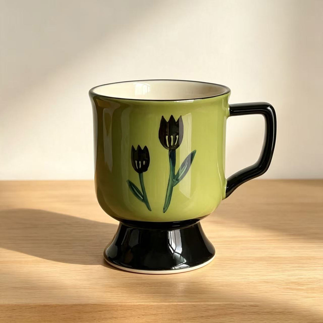 Ceramic cup with foot and hand-painted tulip motif