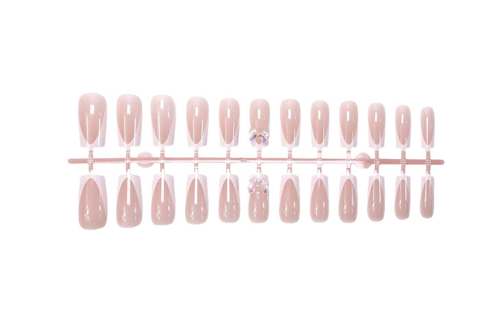 Artificial nail set with luxurious French tips and elegant jewelry embellishments Kalsten