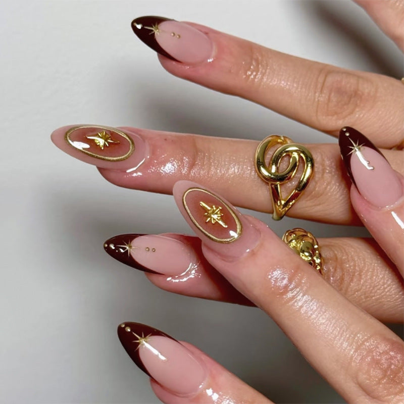 Artful stiletto nails with elegant gold embellishments Kalsten
