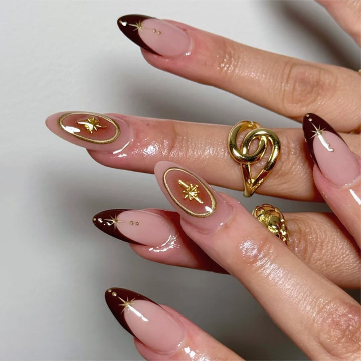 Artful stiletto nails with elegant gold embellishments Kalsten