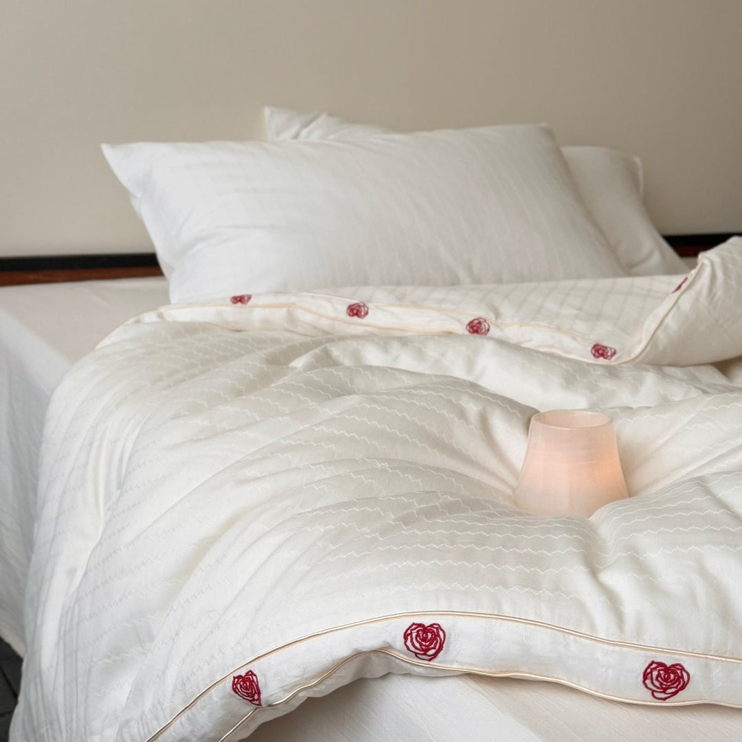 Quilt made of cotton satin with embroidered rose trim