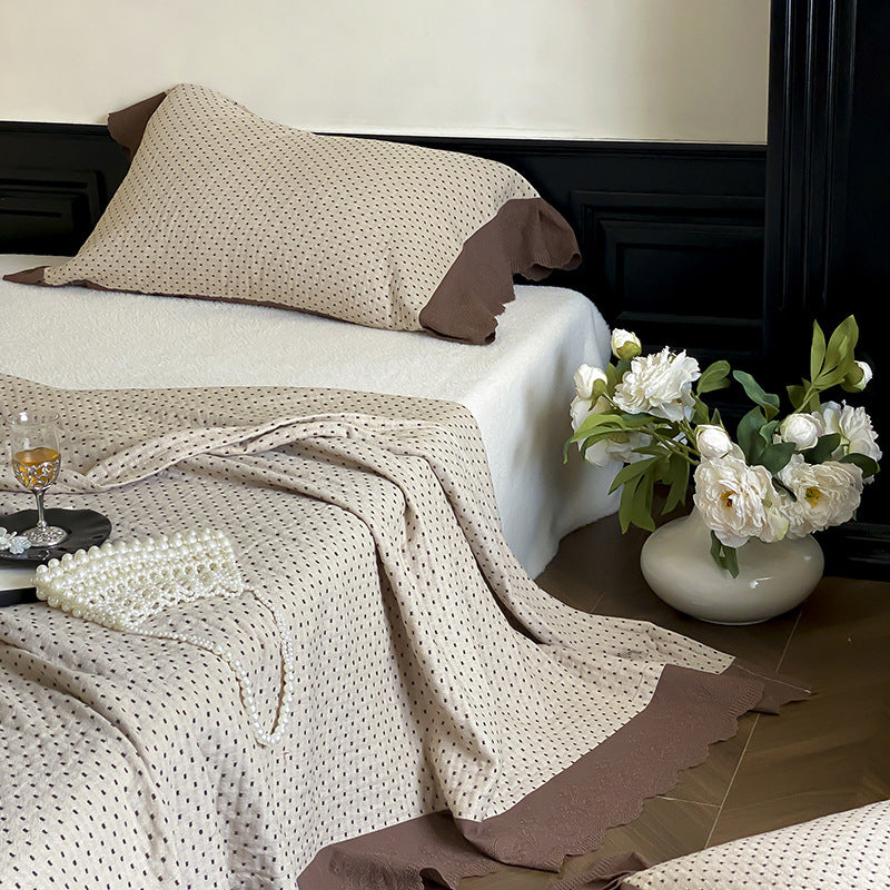 Quilted bedspread and pillowcase set with waffle texture and contrasting ruffle