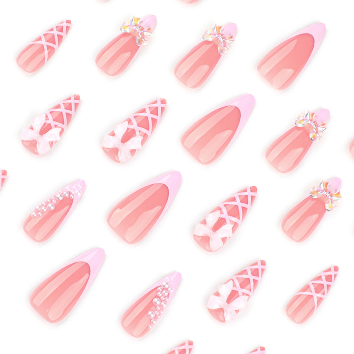 Artful stiletto nails with glitter and bow decoration Kalsten