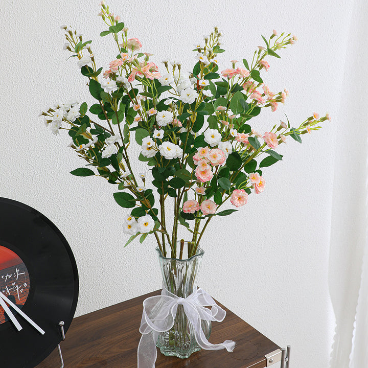 Artificial branch with decorative flowers