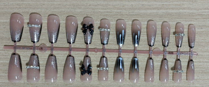Elegant nail design with bow and rhinestone details Kalsten
