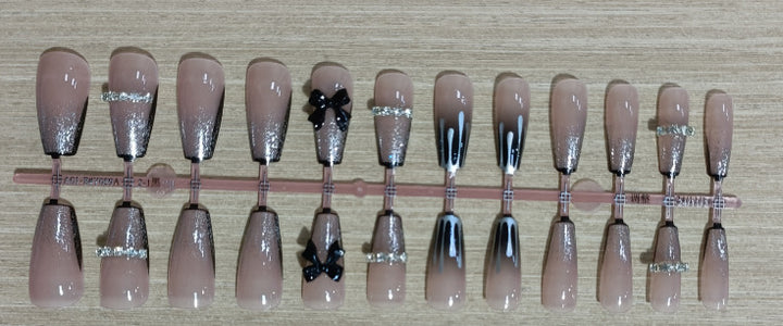 Elegant nail design with bow and rhinestone details Kalsten