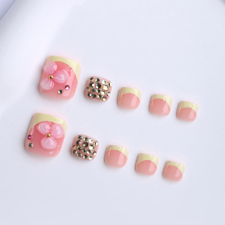 Artificial nail extensions with flower design and glitter accents Kalsten