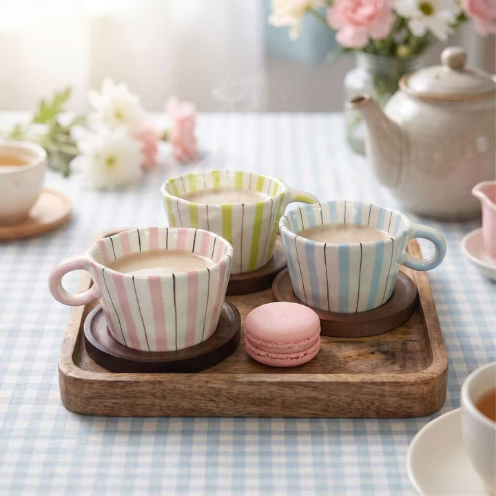 Ceramic coffee mug with ergonomic round handle and fine striped texture