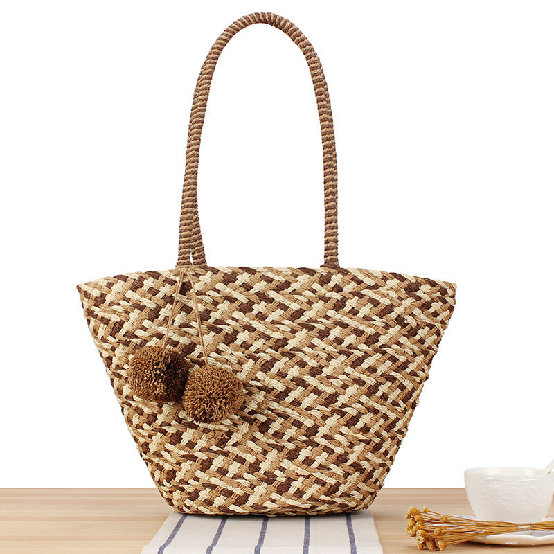Fashionable basket bag with decorative pompons Kalsten