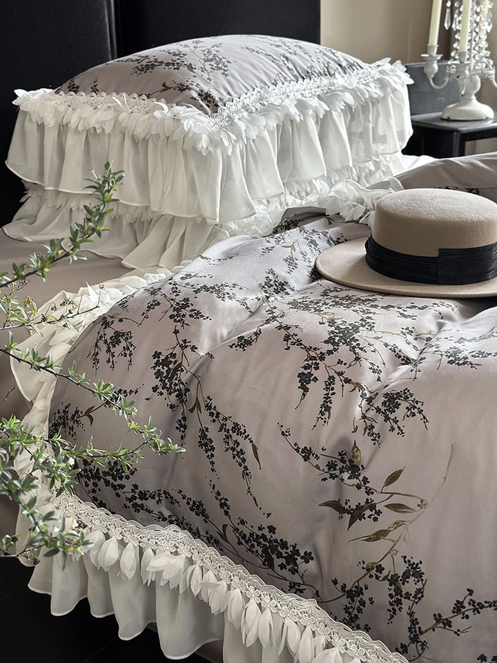 Satin bedding set with floral print duvet, tiered ruffle pillow & lace trim
