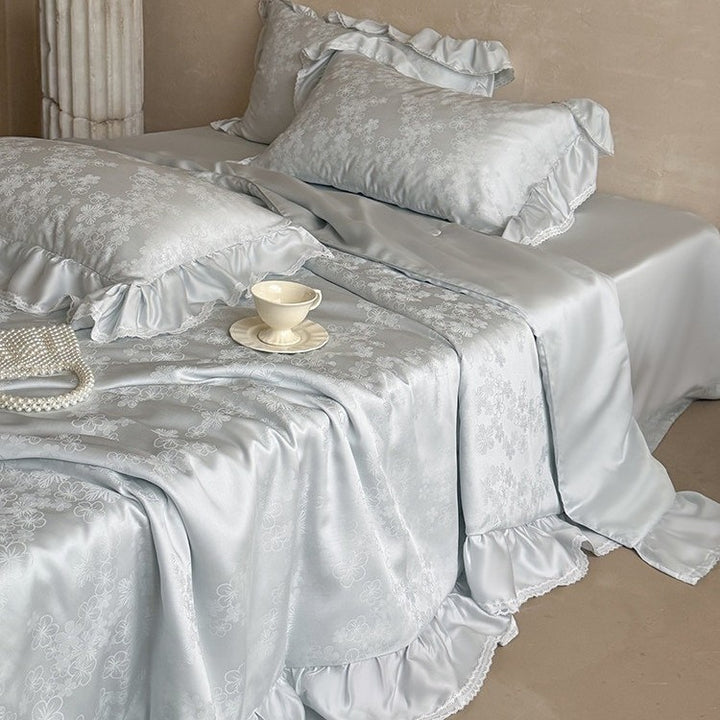 Luxury satin bedding set with floral jacquard pattern, ruffle, and silky finish