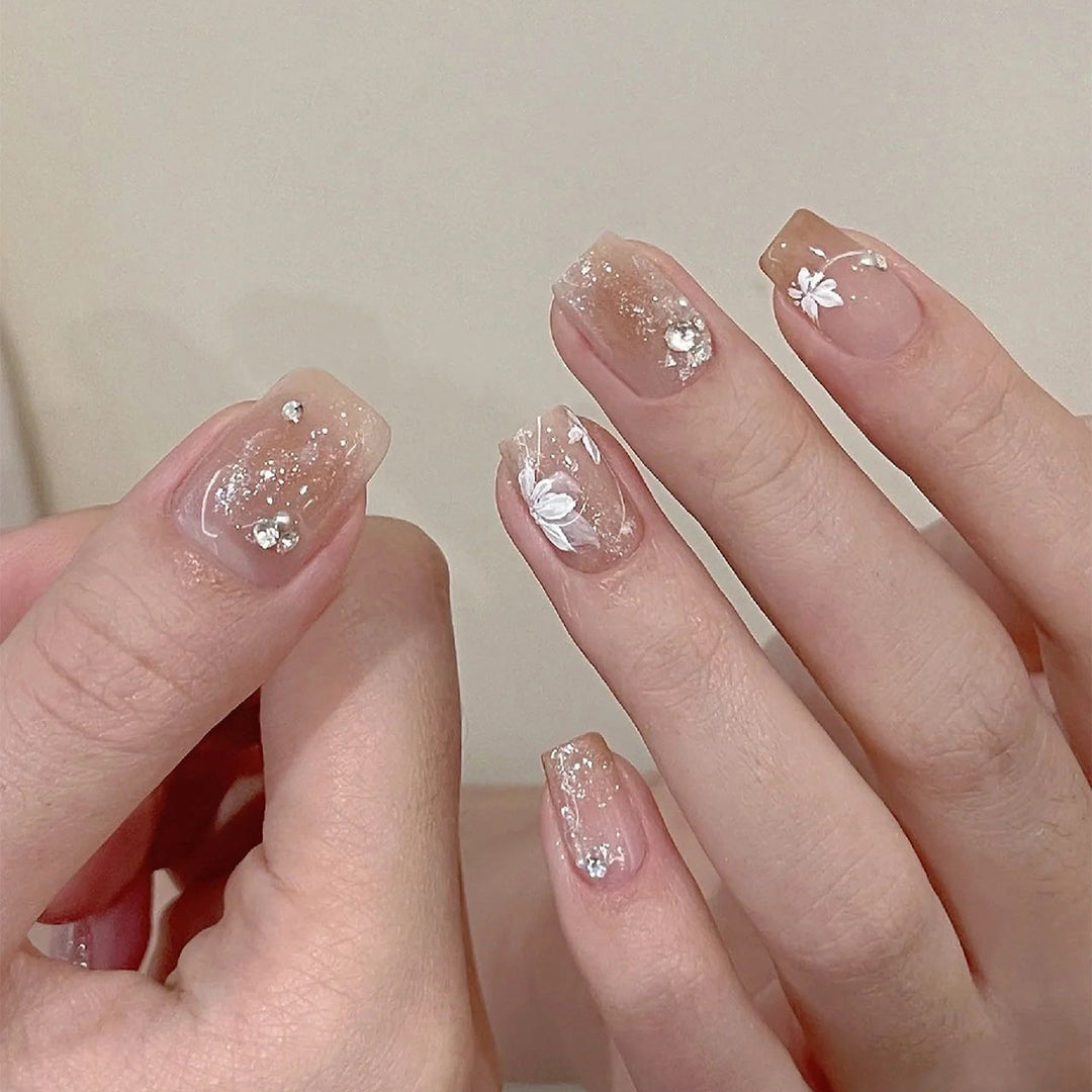 Elegant Nail Art with Holographic Accents and Floral Embellishments Kalsten