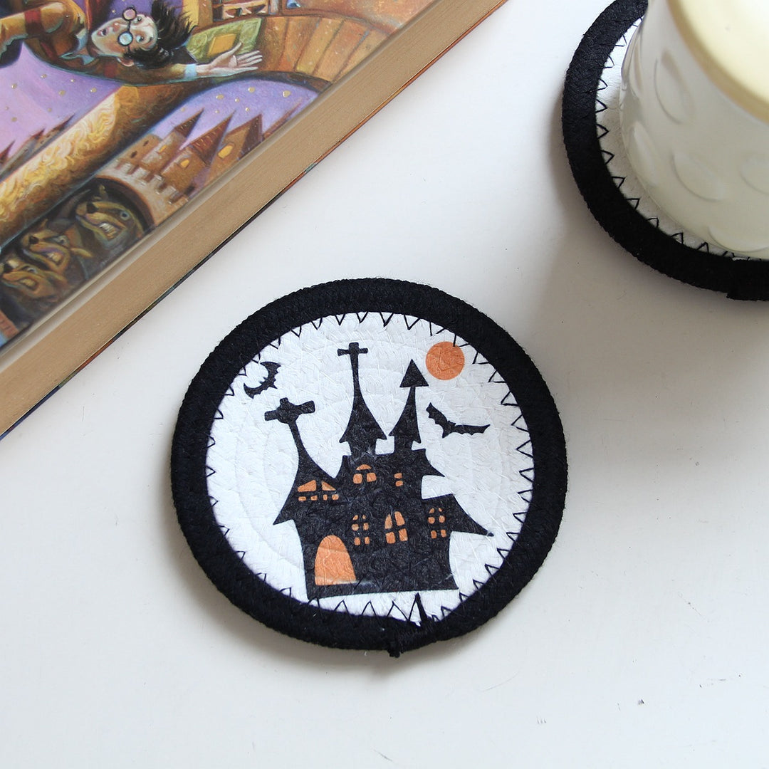 Round felt and cotton coasters with embroidered Halloween haunted house motif