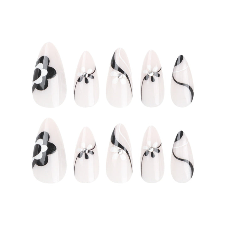 Artistic nail extensions with floral accents and glitter accents Kalsten