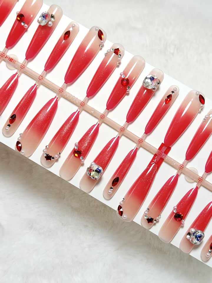 Glamorous artificial nails with sparkling ombre effect and elegant embellishments Kalsten