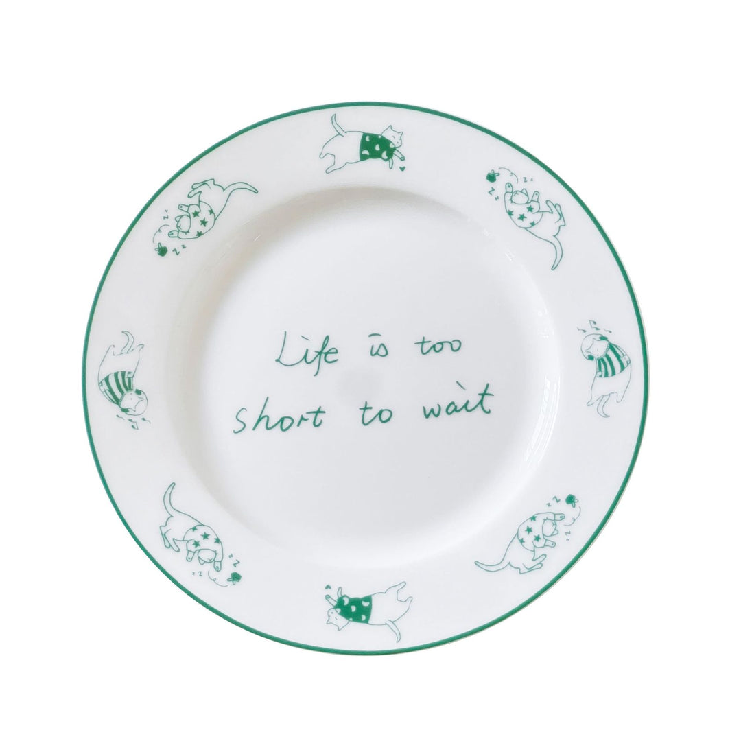Decorative ceramic plate with cat motif and green border decoration