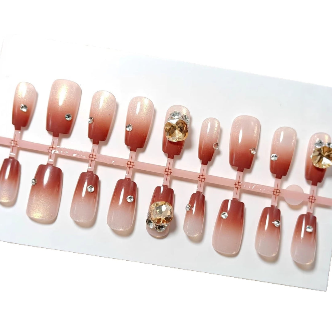 Artificials nails in elegant ombre style with rhinestone embellished applications Kalsten