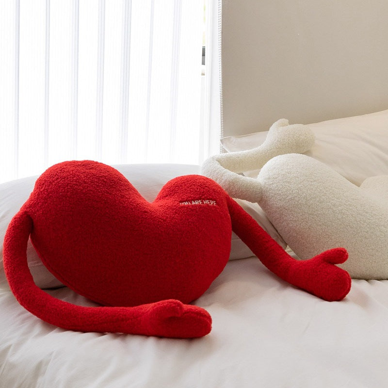 Cuddle pillow in heart shape with extra long arms made of sherpa fleece and embroidery detail
