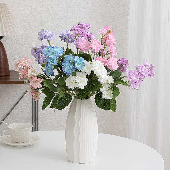 Artificial flower arrangement with delicate white blooms