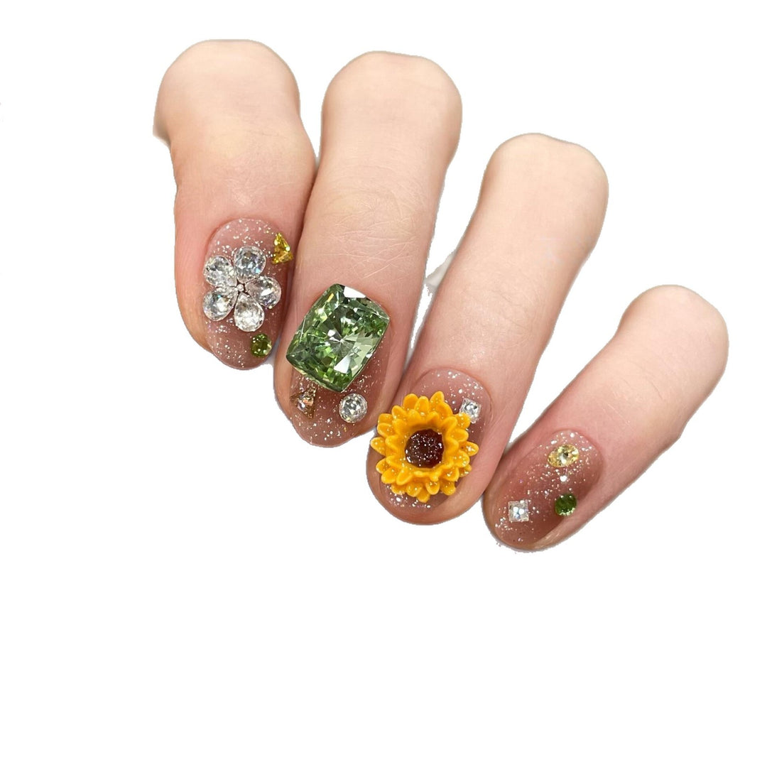 Artificial nails with sparkling appliqués and floral designs Kalsten