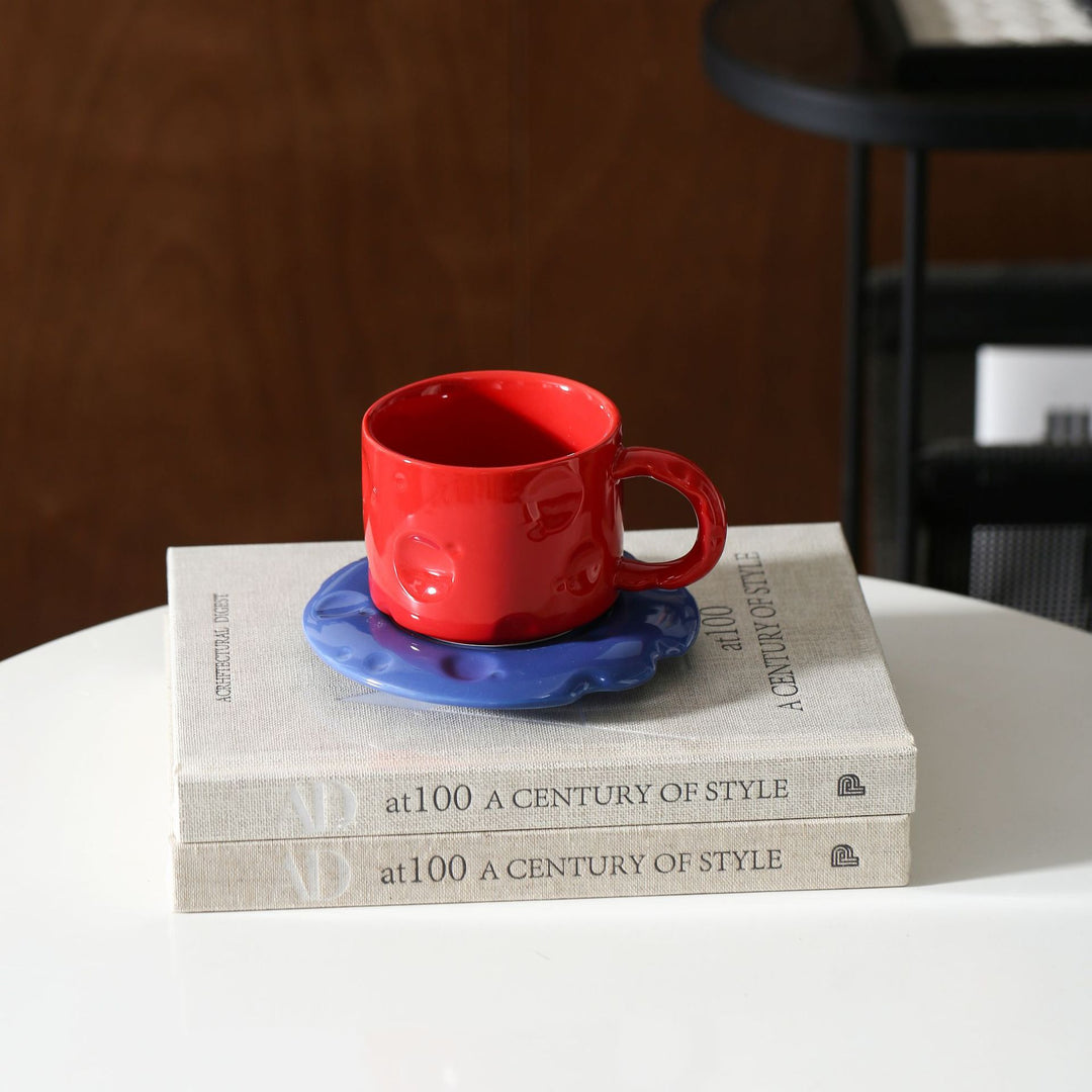Ceramic coffee cup set with textured relief surface and wavy saucer