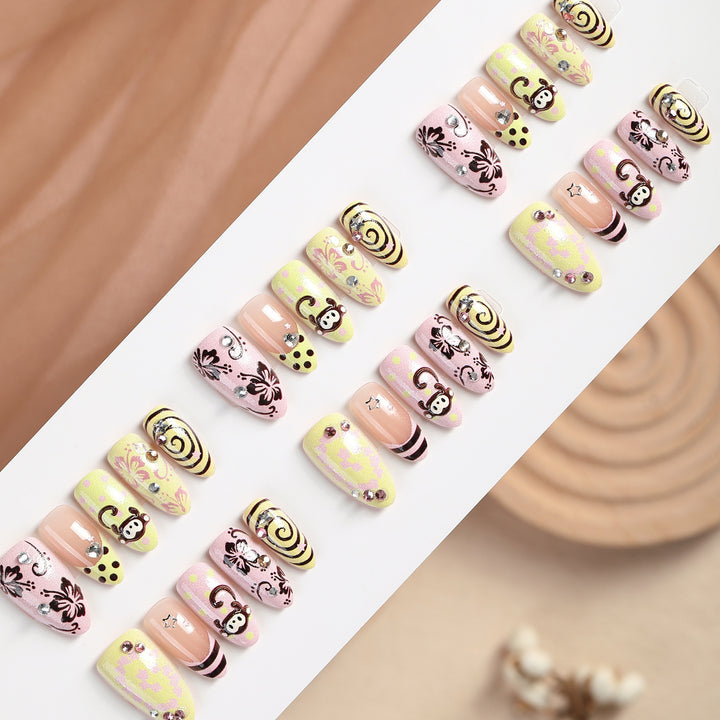 Creative nail art set with playful monkey designs and glitter details Kalsten
