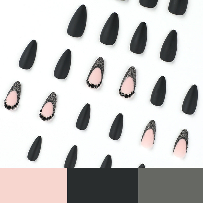 Artful stiletto nails with elegant black design and glitter accents Kalsten