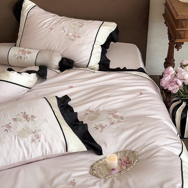 Elegant satin bedding set with floral embroidery relief look, ruffle and contrasting piping seam