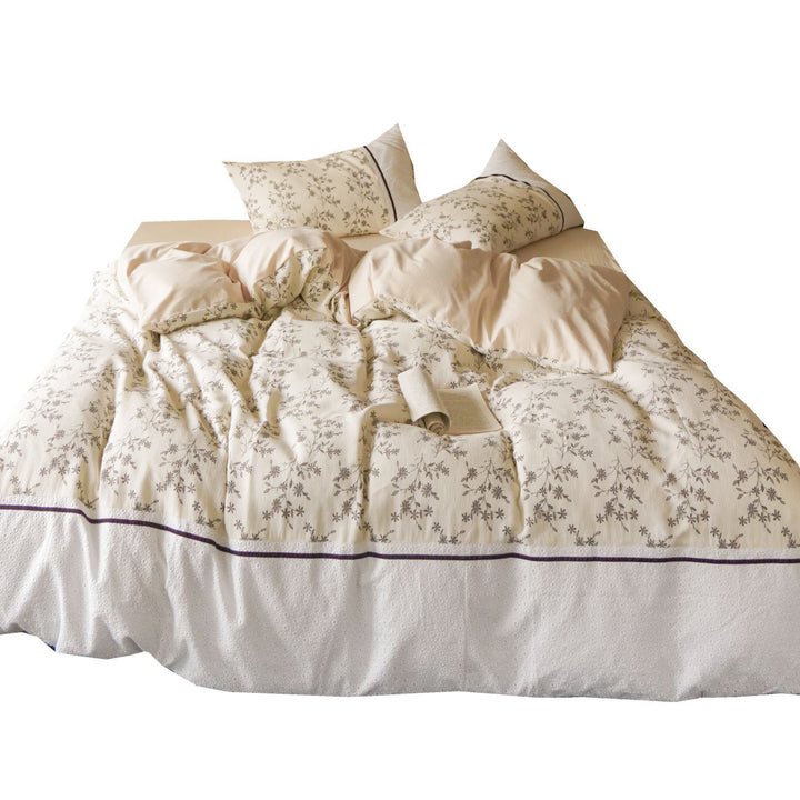 Cotton bedding set with waffle structure, fine floral print and decorative ribbon