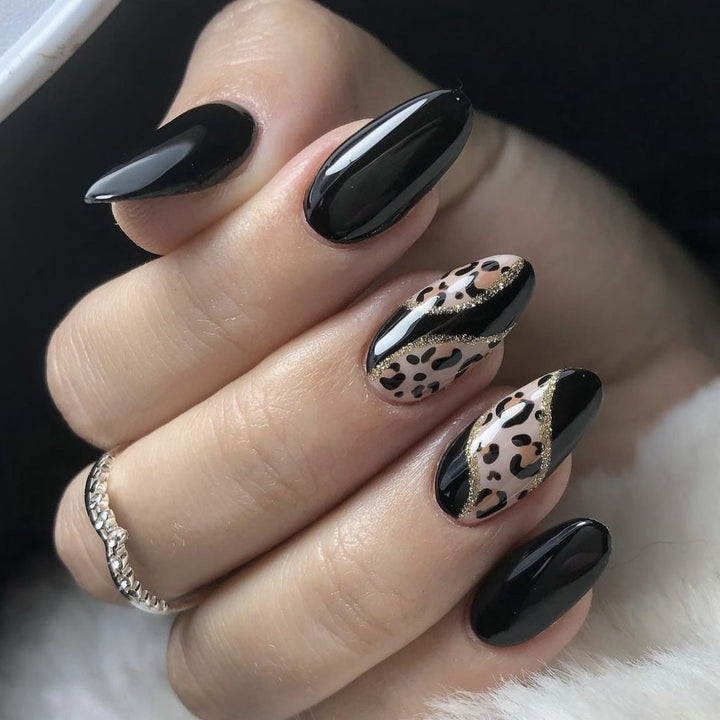 Artistic stiletto nails with leopard design and glitter effects Kalsten